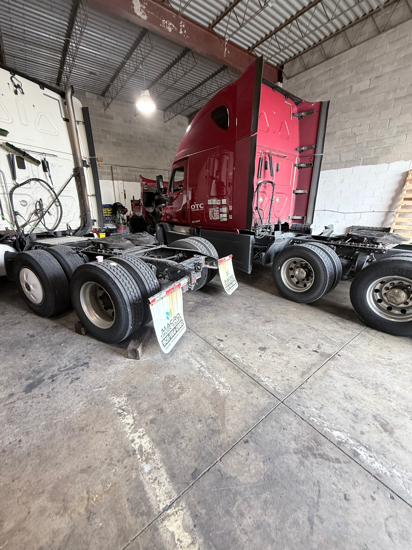 Red semi-truck in A911 repair shop